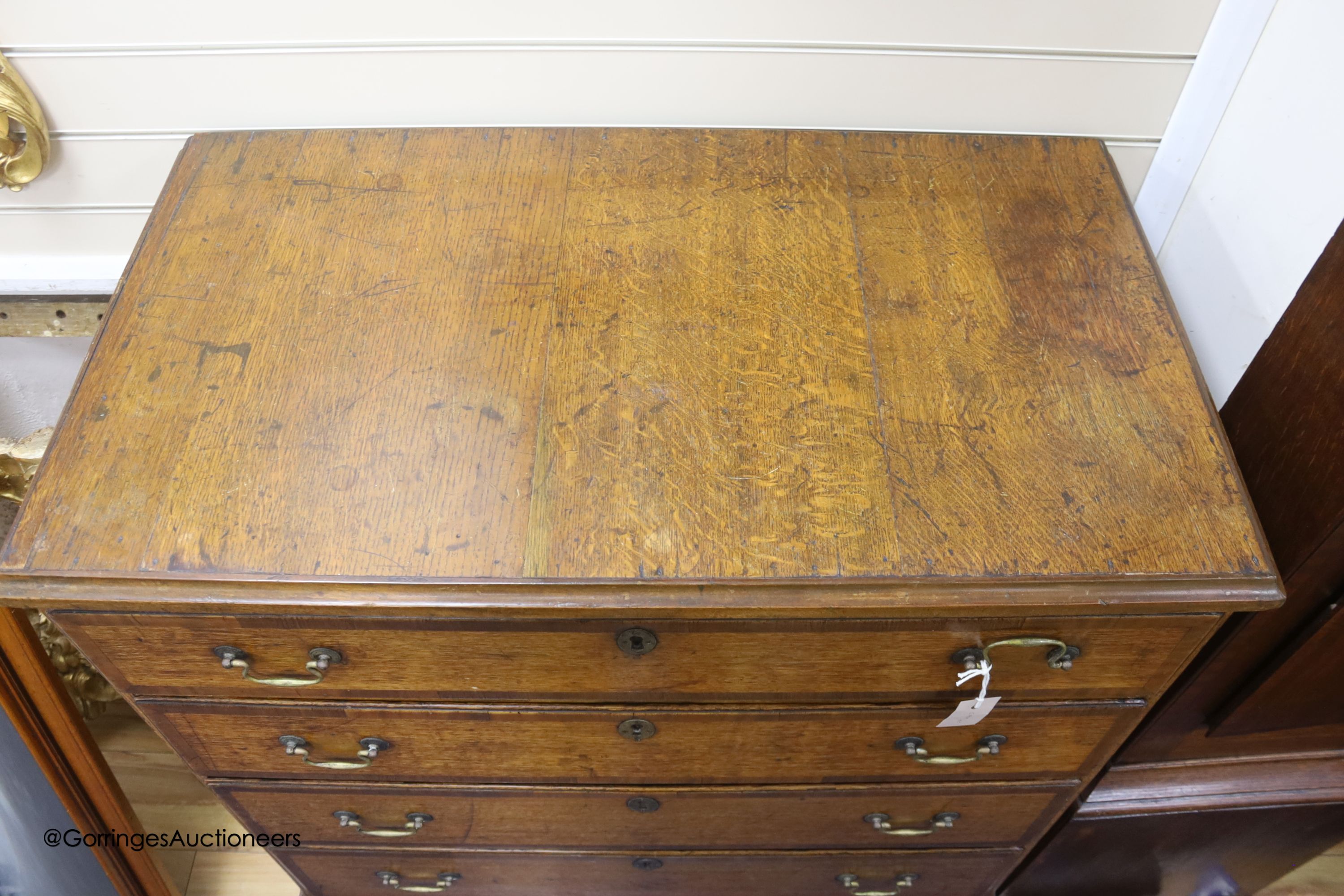 An 18th century oak chest of four graduated drawers